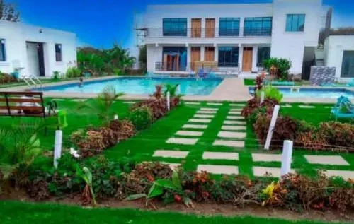 Villa Naserian's main building, pool and garden in Kimana