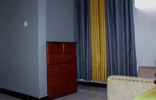 Chest of drawers and curtains in a guest room